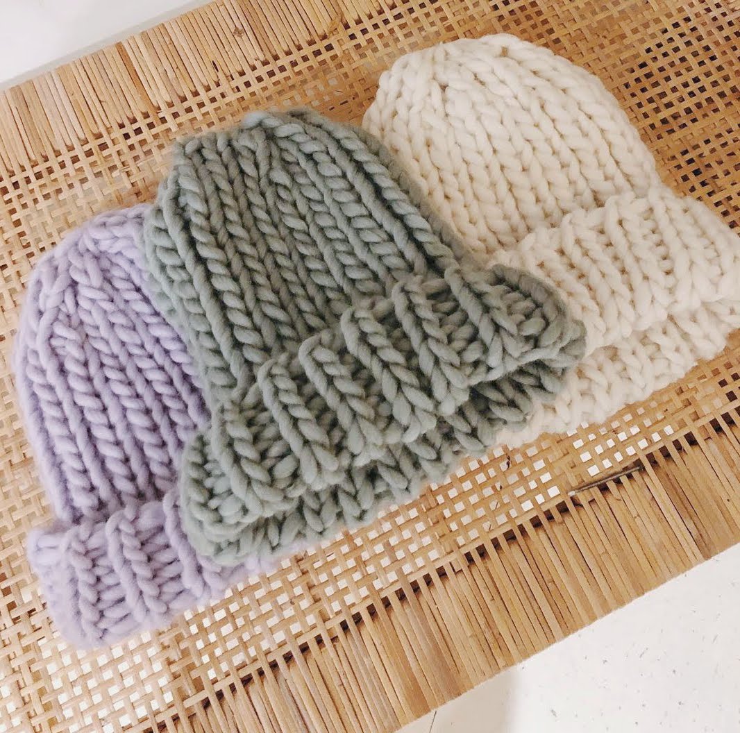 Three chunky hats shown in Lilac, Sage and Ivory